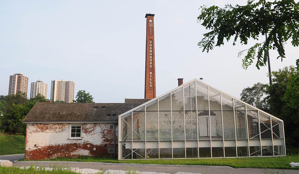 Historic buildings with glass house and brick chimney stack