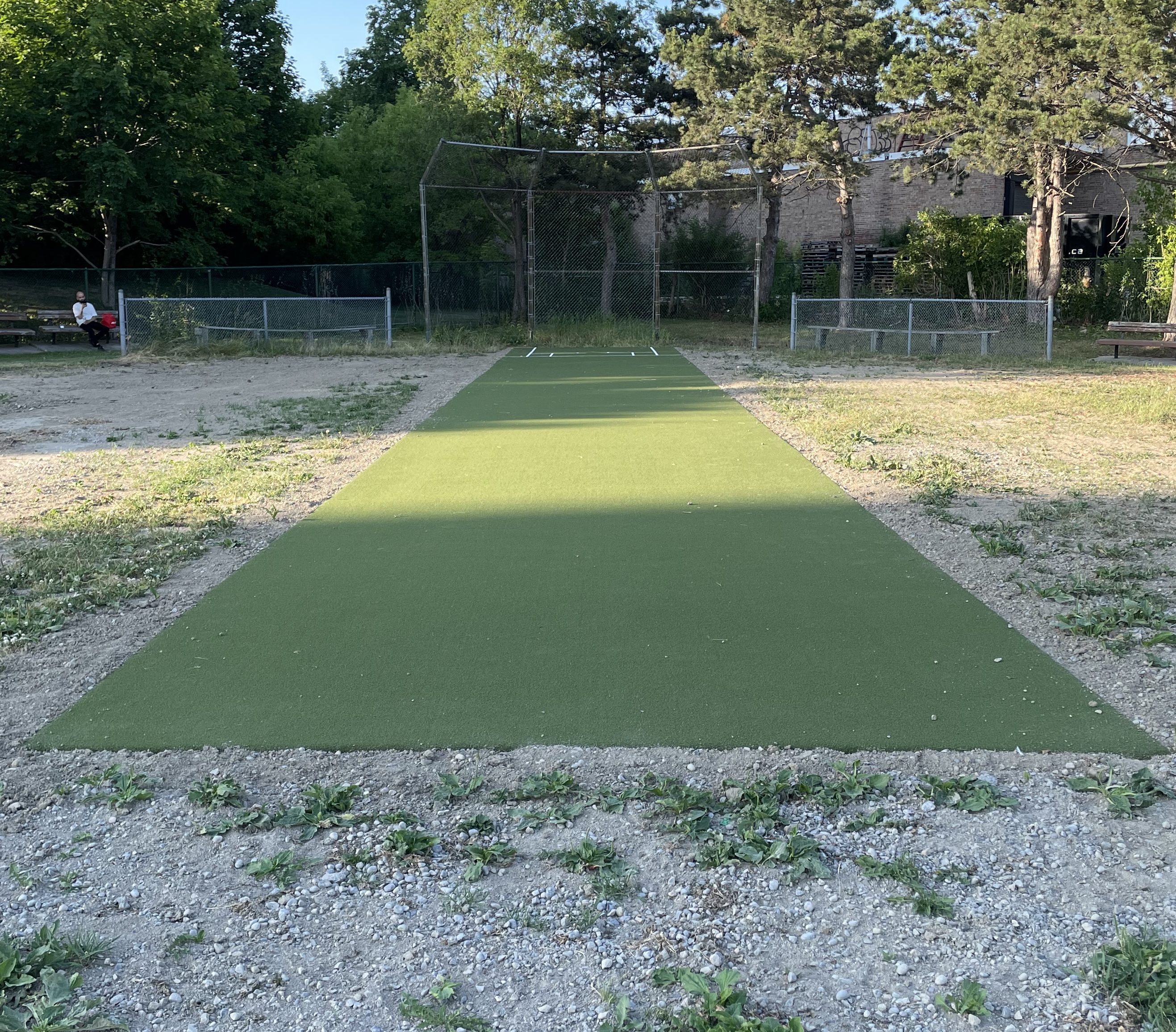 Parma Park single-direction cricket pitch with backstop and player seating. It is mostly complete. 
