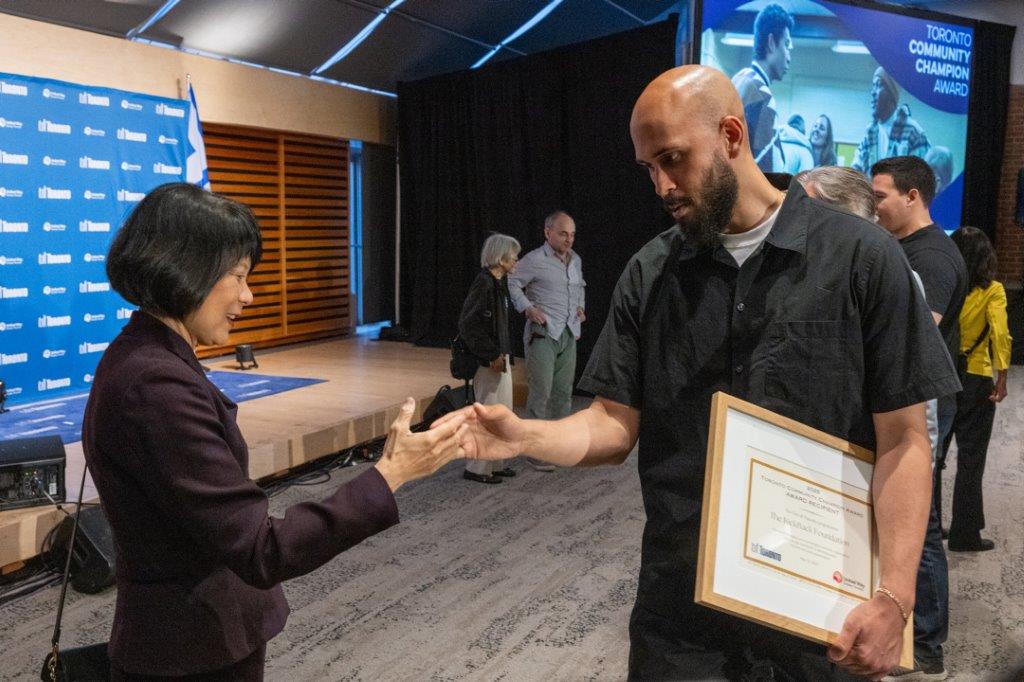 Award recipient shaking hands with the Mayor
