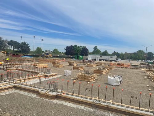 Centennial Park soccer hub under construction, focusing on the foundation work in progress for the new fieldhouse building.