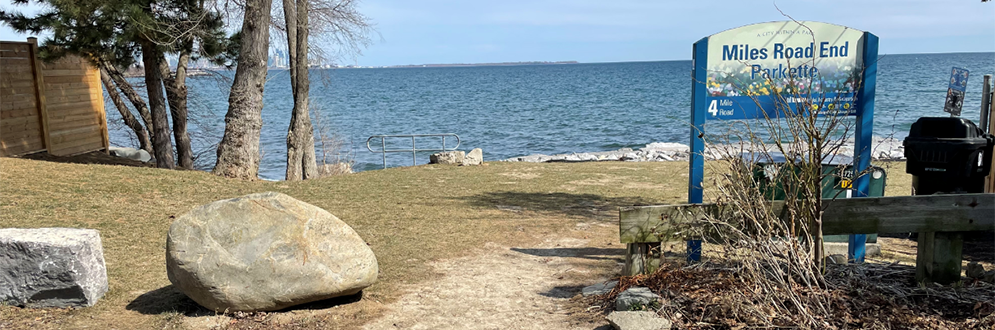 The Miles Road End Parkette sign with the lake in the background.