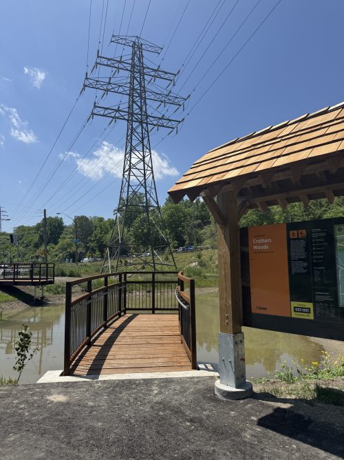 Trail with signage to the right reading Crothers Woods. 