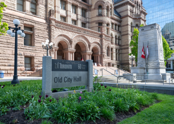 Front entrance of old city hall with garden in foreground