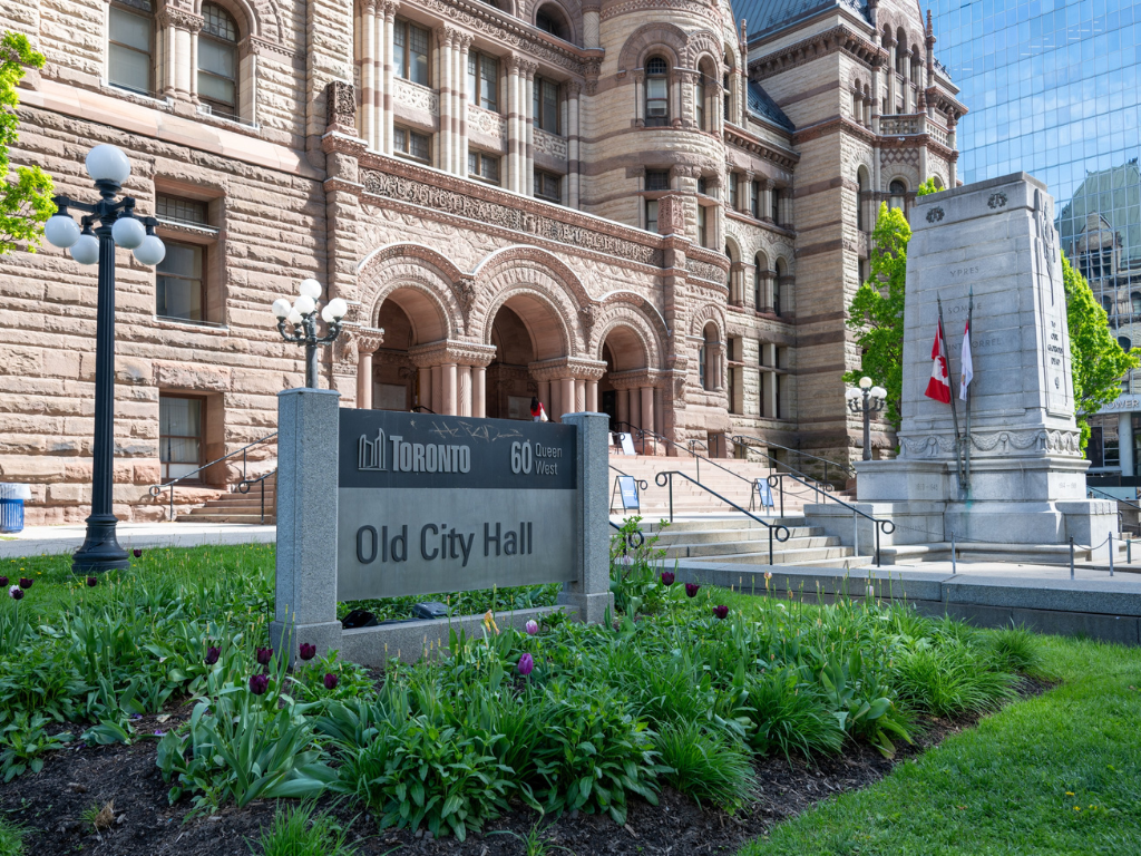 Front entrance of old city hall with garden in foreground