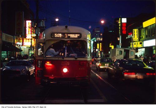 Colour photograph of PCC streetcar at night.
