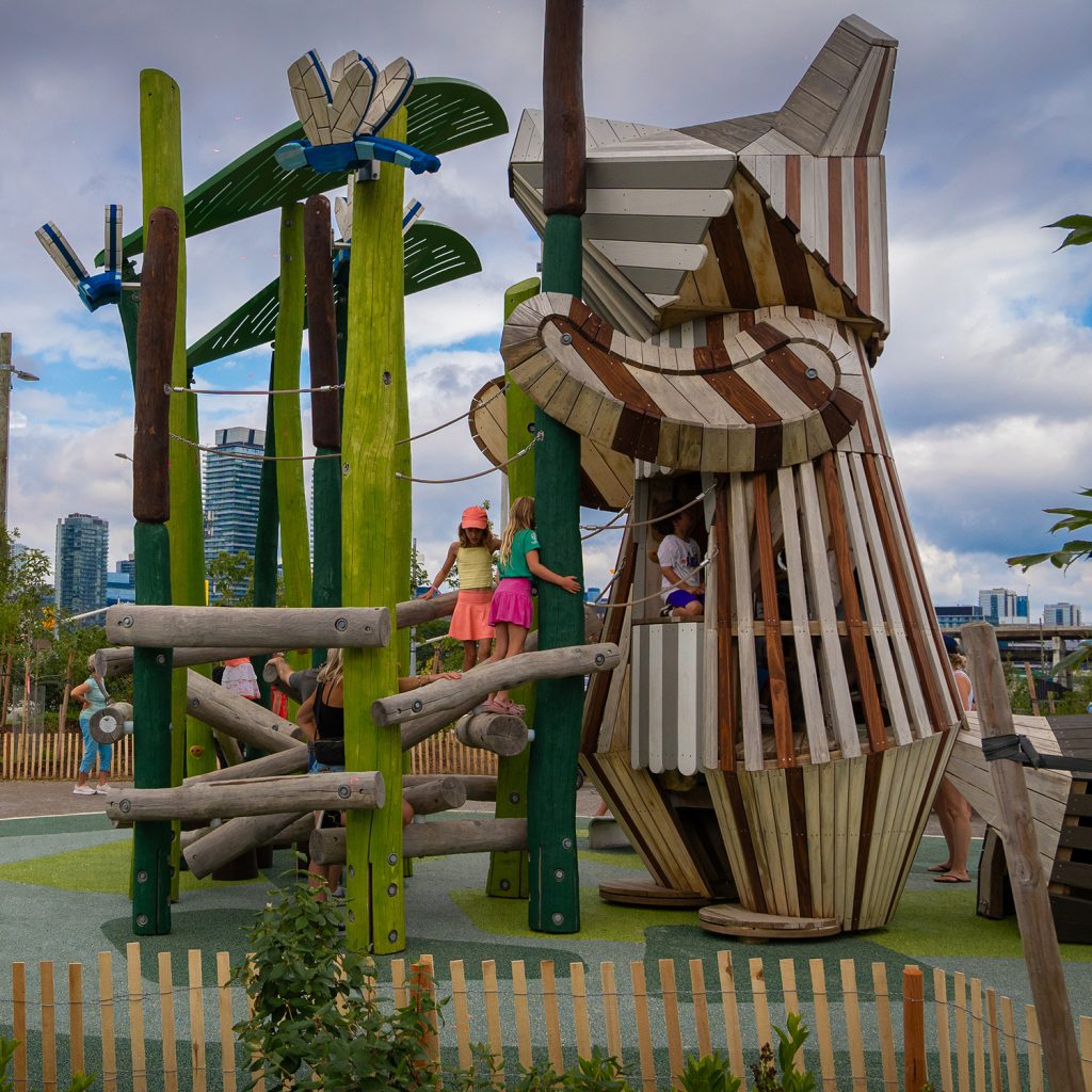 Climbing play structure in the shape of a raccoon.
