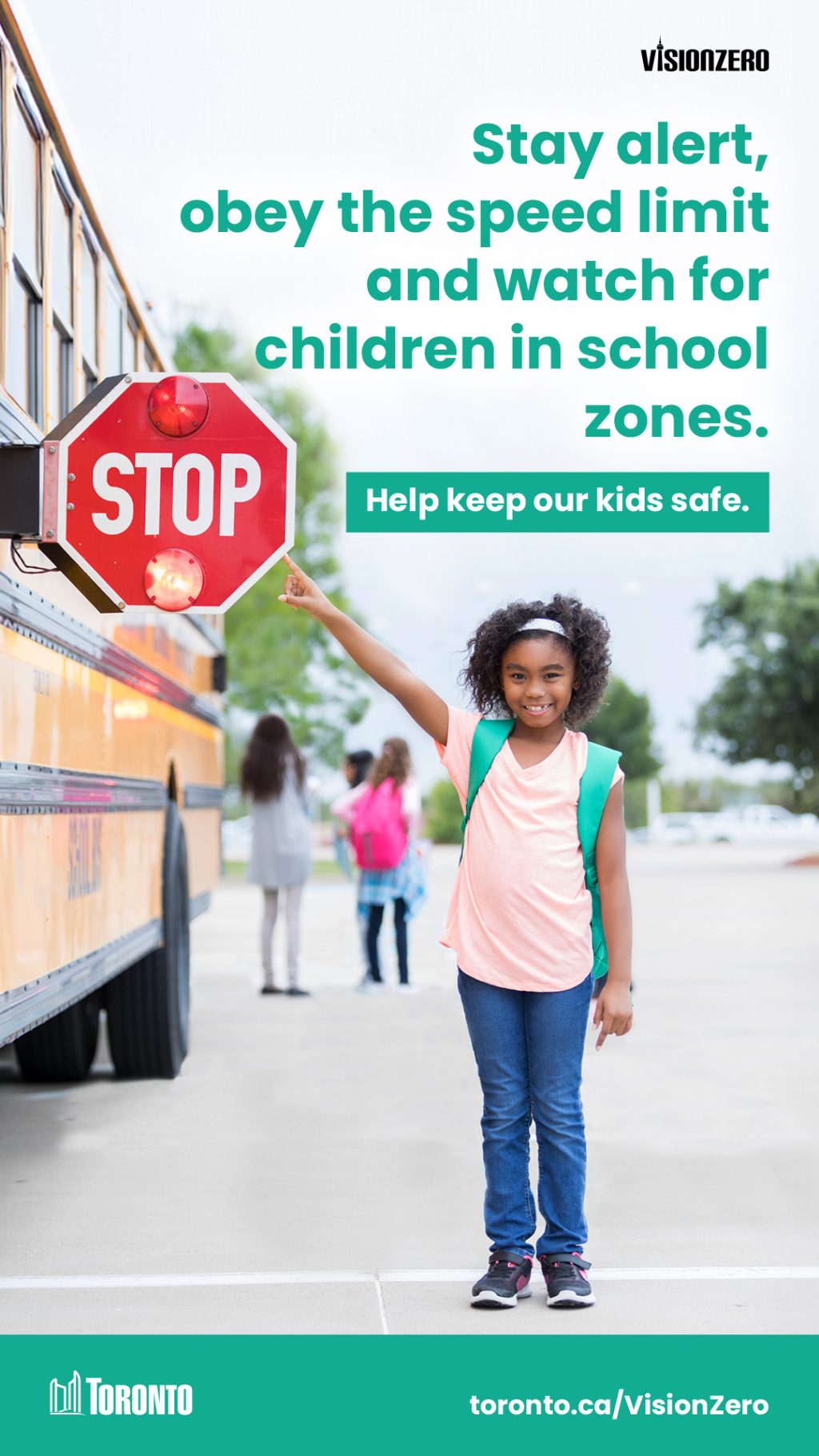 Image of a child pointing to the stop sign on a school bus