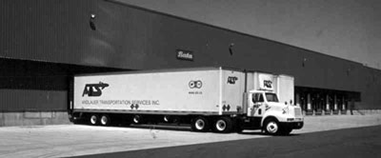 Freight trucks parked at a warehouse.