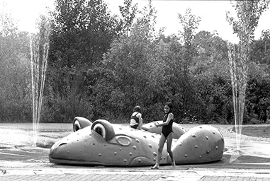 Children play at a splash pad.