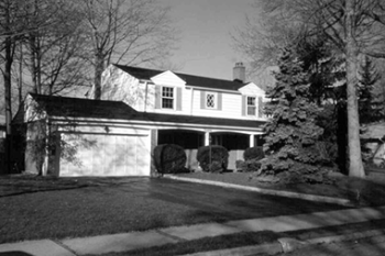 - A two storey detached single family house with two car garage and treed front yard.