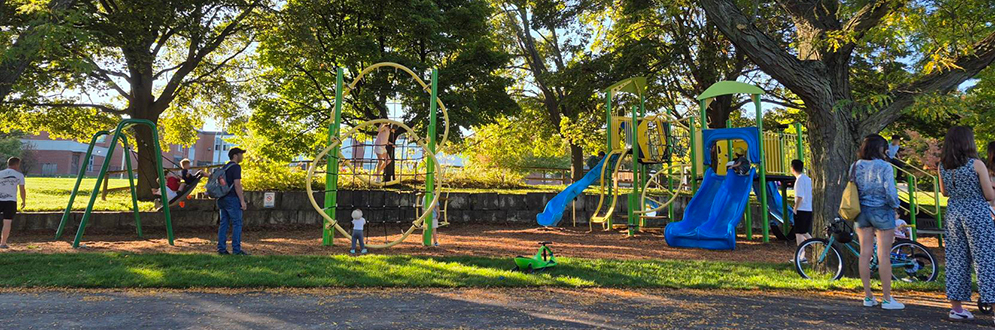 A brightly coloured playground with swings.