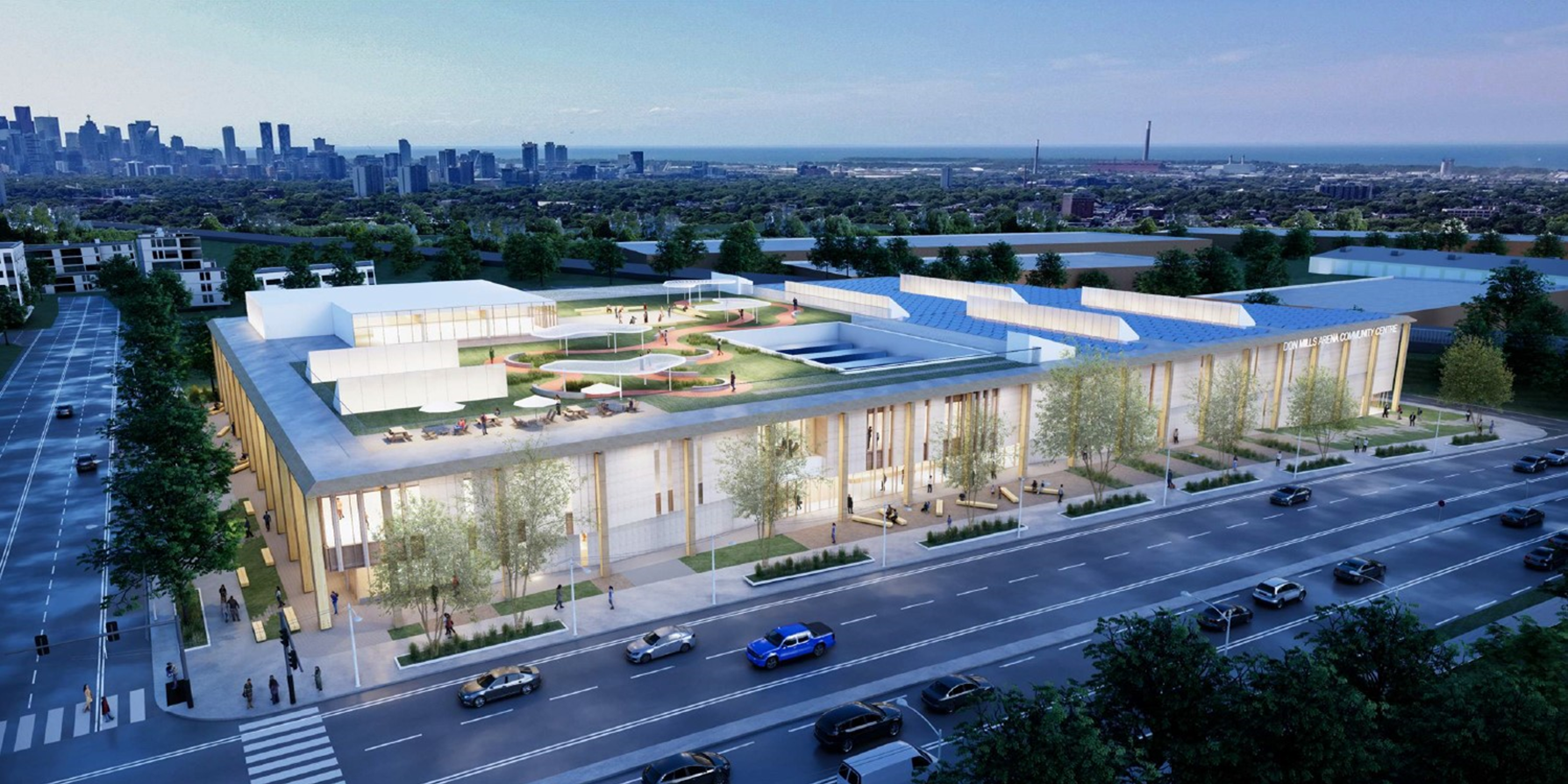 Rendering of the aerial view of the new community recreation centre from Don Mills Road at night showing the green roof and surrounding area.
