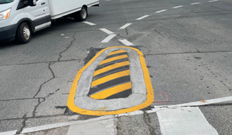 Example of a speed hump at center-line on a roadway.