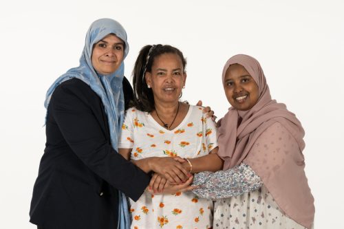 Three women embracing 