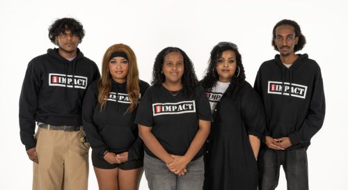 Five IMPACT Team members wearing shirts with the impact branding 