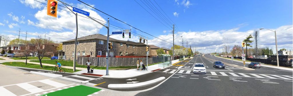 Artistic rendering of proposed changes at the west side of Morningside Avenue and Tams Road. Pedestrians are waiting on the sidewalk to cross the road. On the road next to the corner there is a path for bicycles to turn and then a raised concrete median that is between the road and bike turning area. A cyclist is riding on the bike path on Tams Road. Next to the crosswalk on Morningside Avenue is a crossride painted green. A man and a dog are waiting to cross from the north side of Tams Road to the south side. There are cars are driving south and north on Morningside Avenue.