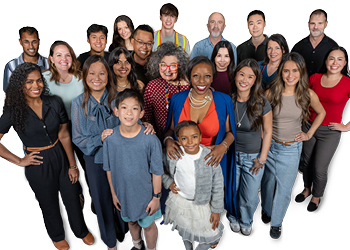 A large group of diverse people standing in front of a white backdrop posing for a photo.