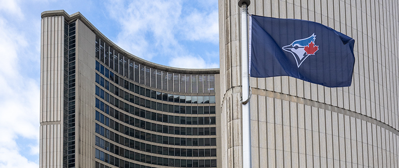 Toronto Blue Jays flag flying in front of Toronto City Hall