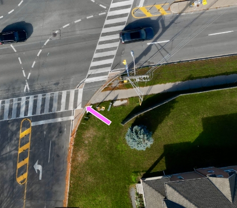 Photo showing an example of a curb radii reduction. The pink area identifies the planned painted area.