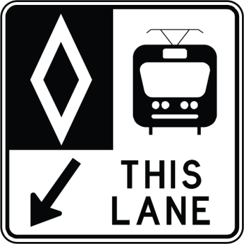 Traffic sign indicating a reserved lane for streetcars. The sign includes a diamond symbol, a streetcar icon, an arrow pointing down and the words ‘THIS LANE.’