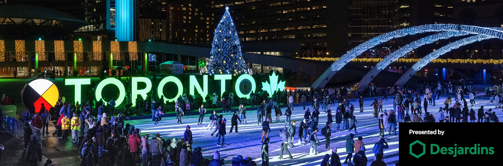 Night scene of skaters on rink in front of green Toronto sign, Christmas tree and City Hall. Presented by Desjardins in bottom right corner.