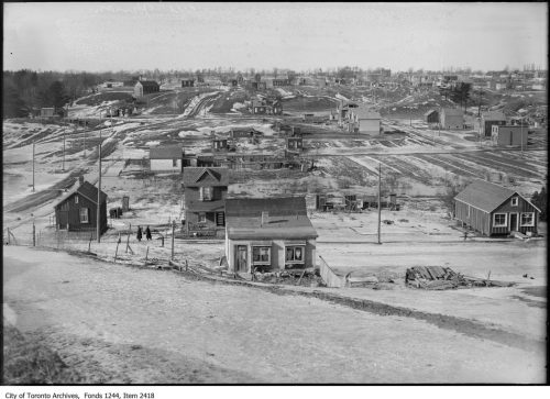 Monochrome image depicting construction site of suburban housing development.