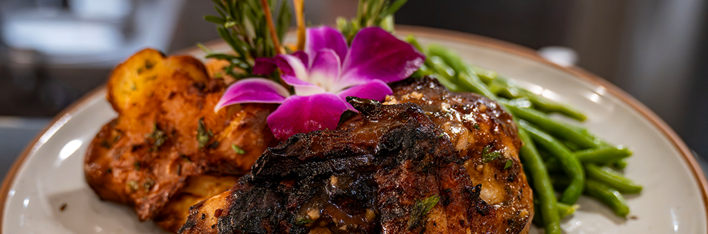 Chicken dinner with asparagus and a decorative pink flower