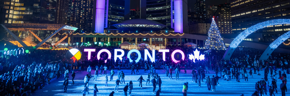 Cavalcade 2026, with skating in the foreground, the Toronto sign and then City hall in the background.