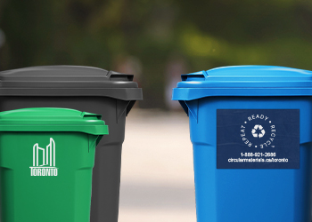 Garbage and Green Bin with City of Toronto logo on the left and a blue recycling bin with Circular Materials logo on the right.