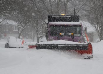 A snow plow clearing a street in Toronto
