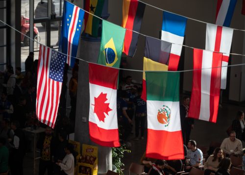 Several country’s flags, including Canada, the United States of America and Mexico’s, hanging from rafters.