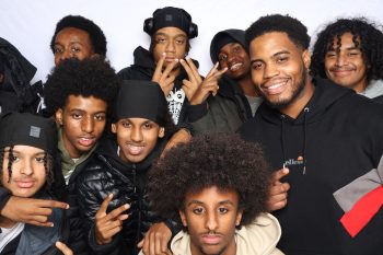 A group of youth leaders gathered with a community leader at the 2025 TSNS Summit at the Scarborough Civic Centre, posing together in front of a light backdrop