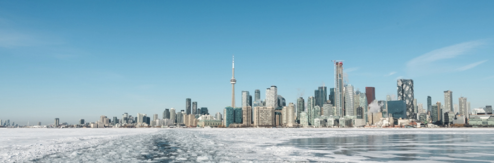 Skyline of Toronto showing CN Tower and icy lake.