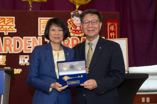 Photo of Mayor and recipient Dr. Wong holding a blue velvet box