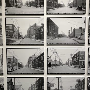 Image depicts close up of archival monochrome photographs on wall