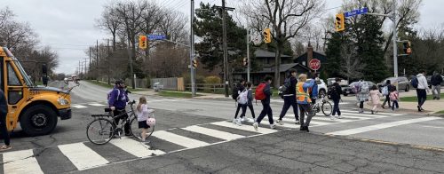 Image of school children crossing the road at St Clement Catholic School