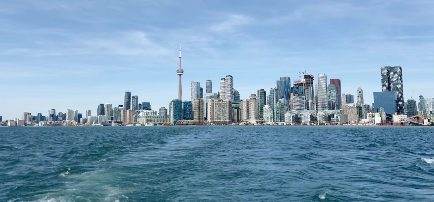 Toronto skyline from a ferry view across Lake Ontario, showing the downtown waterfront