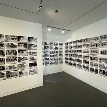 Image depicts close up of archival monochrome photographs on wall
