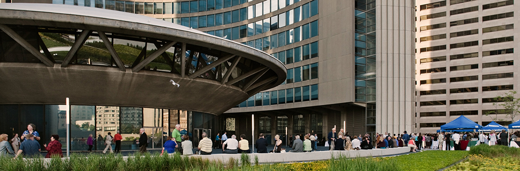 Crowd around City Hall rotunda, tower and garden