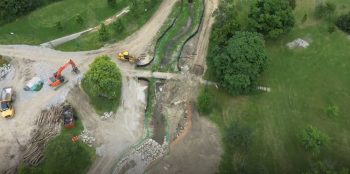 Dirt pathway showing construction vehicles.