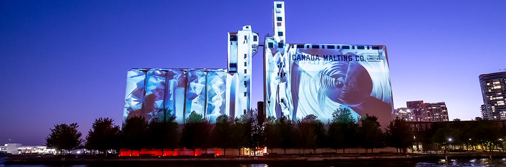Film projected onto Malting Silos at night
