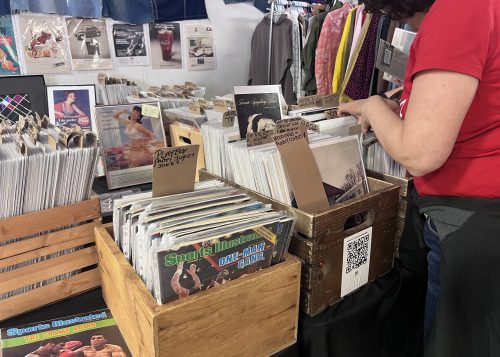 Close up of person riffling through boxes of record albums