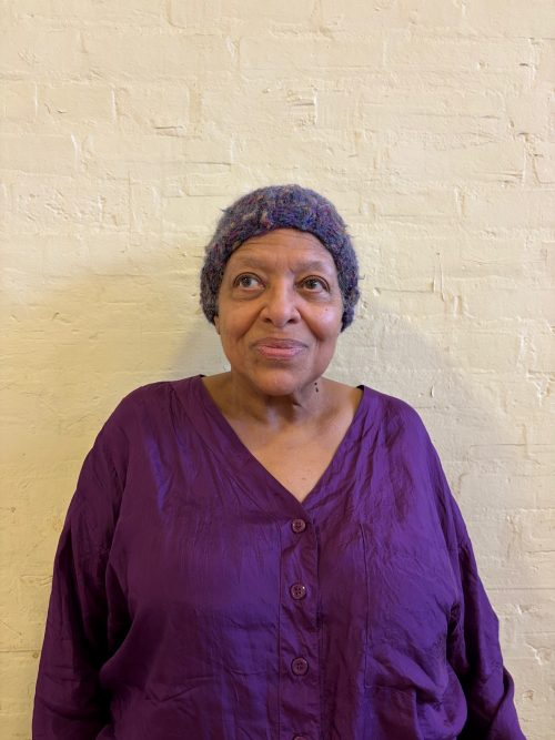 Headshot photograph of women wearing purple top