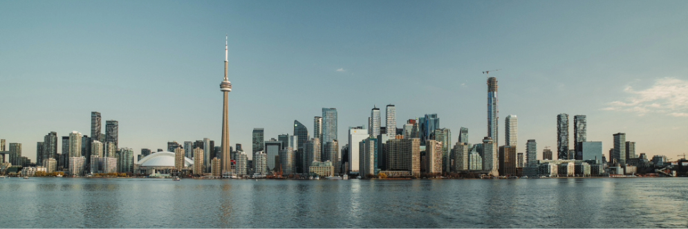 City of Toronto skyline with city buildings, CN Tower and lake on a clear day.