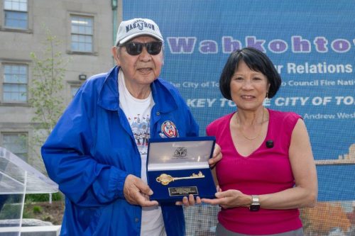 Mayor Chow and Elder Wesley holding the key between them
