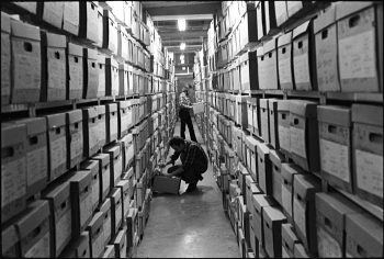 Image depicts archival records centre, with shelves of boxes.