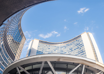 Worm's-eye view of City Hall and blue skies.