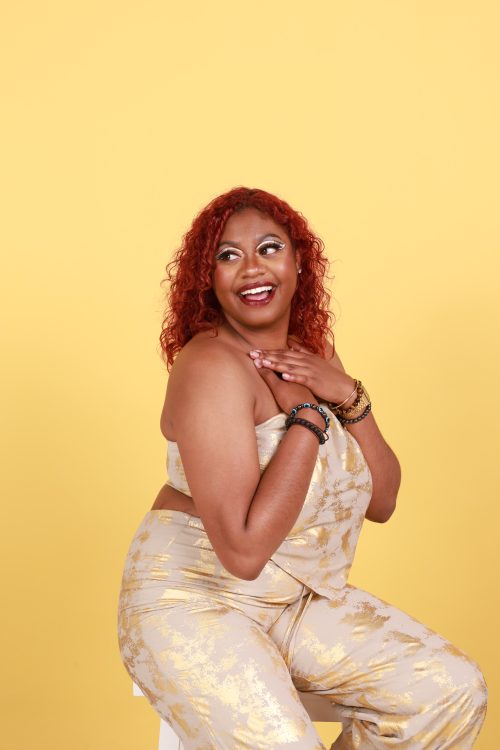 Woman sitting on chair with yellow background
