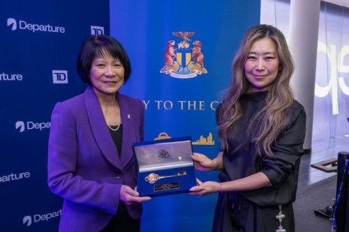 Two people holding a velvet box