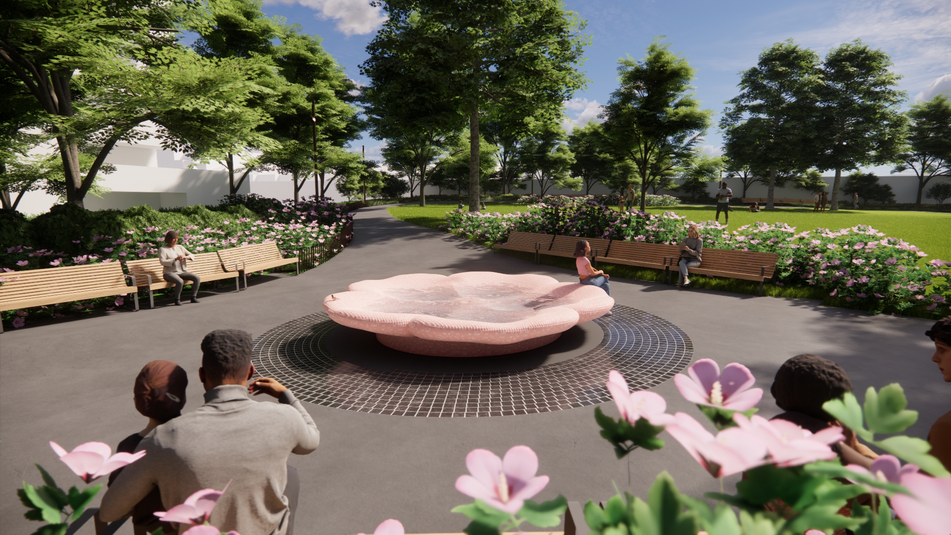 View of the gathering hub: a triangular space framed by benches and rose bushes. At the centre of the space, a rose-shaped water basin serves as the focal point. People are seated on the surrounding benches, relaxing and enjoying views of the water feature and the surrounding landscape. In the background, a mature canopy of trees and a pathway continues beyond the gathering hub, curving around an open grassy lawn.